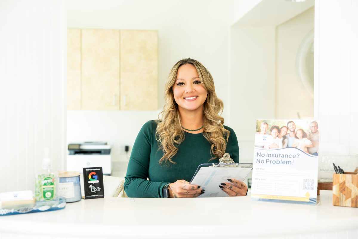 A front-desk team member at Belfast River Dental